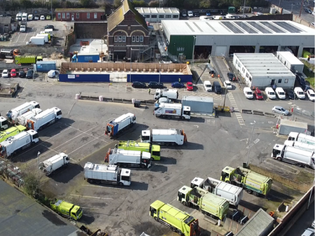 An aerial photograph of a depot with buildings and bin lorries