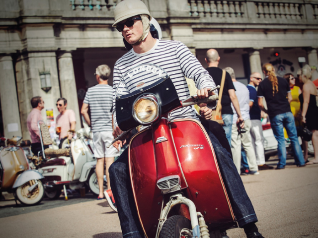 Picture of a Mod riding a red scooter on Brighton seafront. Picture by David Clarke (Dammo Photography.)