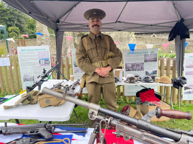 Picture of soldier in WW1 uniform behind a history information stand at Portslade 