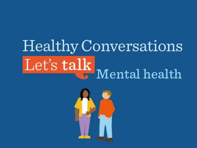 Dark blue background with pale blue text and orange speech bubble icon and graphic of two people talking. Text reads: "Healthy Conversations. Let's talk mental health"