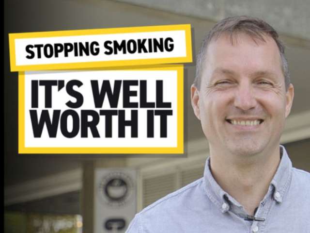 A man smiling at the camera wearing a pale blue shirt. Two boxes outlined in yellow with black writing. Text reads: "Stopping Smoking. It's Well Worth It.