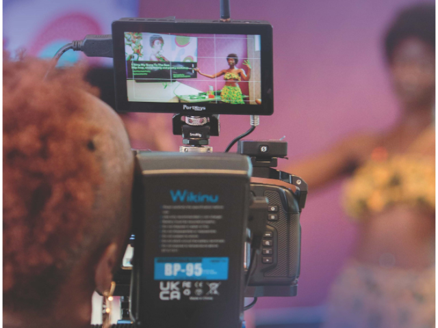 Picture of a person filming taken from the front cover of the Unleashing Potential vision document