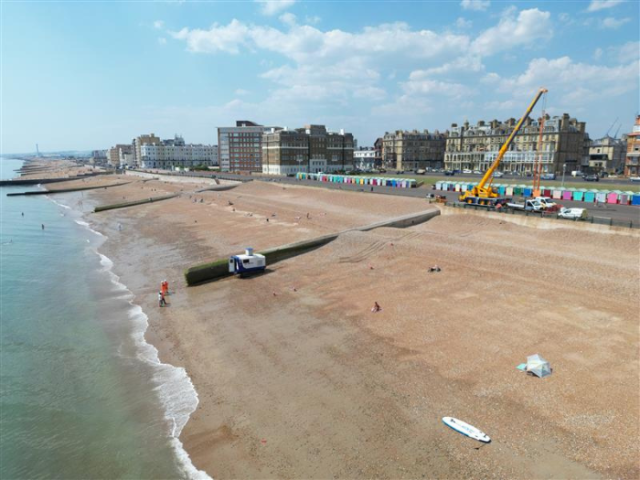 a photo of a beach with a crane 