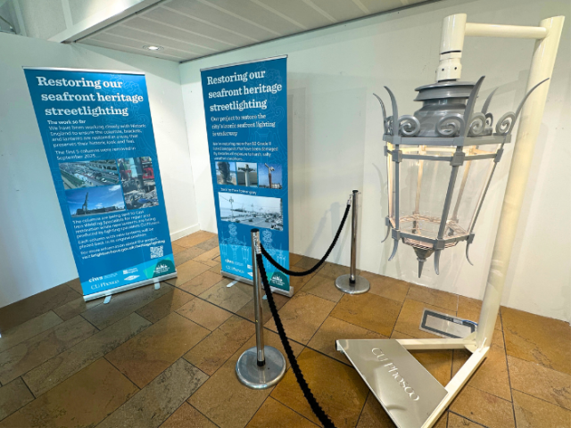 a picture of a street lantern next to two banners with information