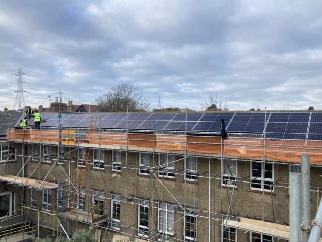 Solar panels being installed on a row of houses in Wayfield Avenue