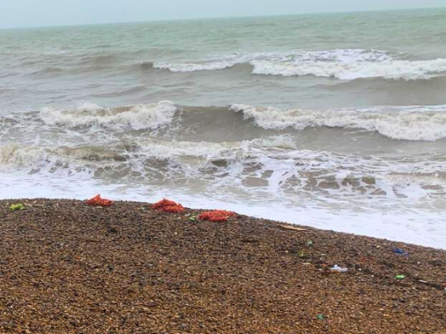 Photo of windy seafront with rubbish on