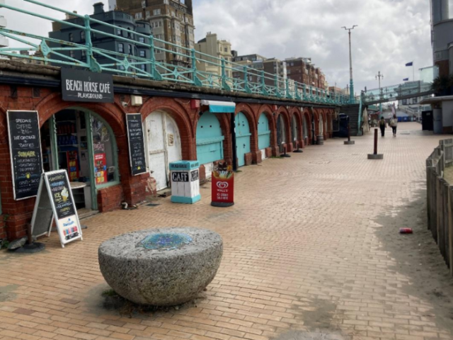 A picture of a promenade and arches under a road