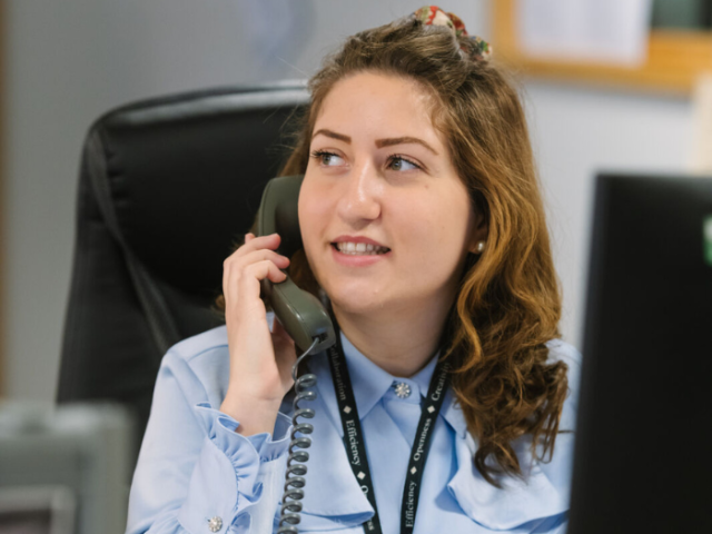 Person holding phone in office setting