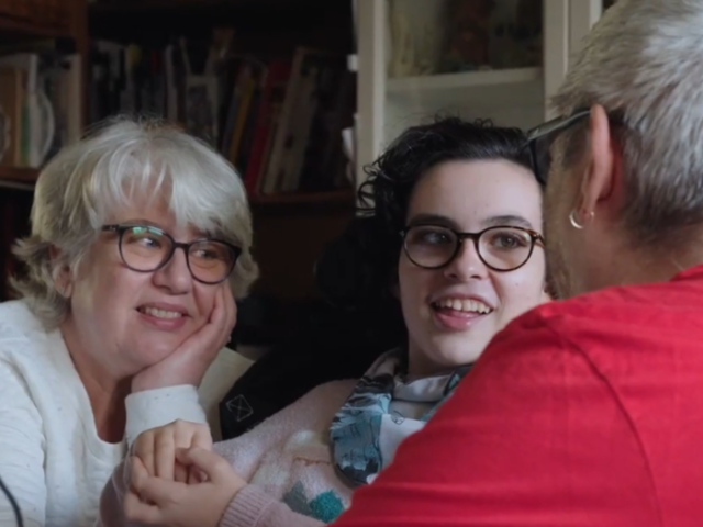 Three people, two can be seen smiling