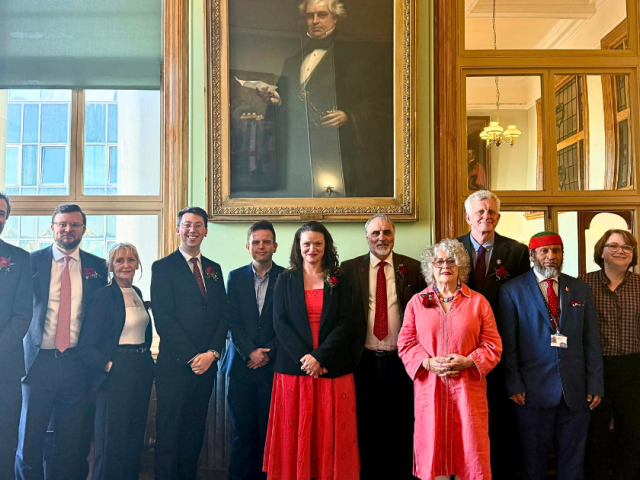 12 Cabinet Members stood in a line in a grand room