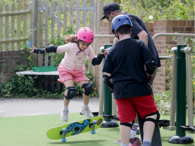 Children practicing skateboarding