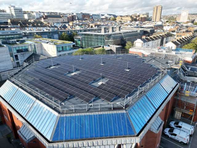 Aerial view of solar panels on the hexagonal roof of the Prince Regent Swimming complex