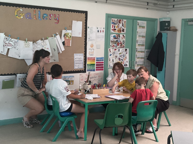 Children from Mile Oak Primary School's Forest Class working around a table