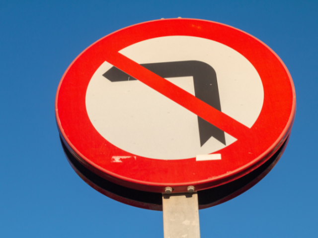 a 'no left turn' road sign