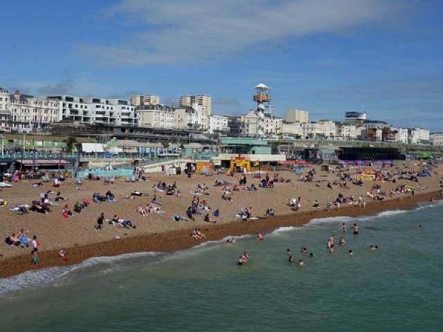 "Brighton beach on a busy summer day"
