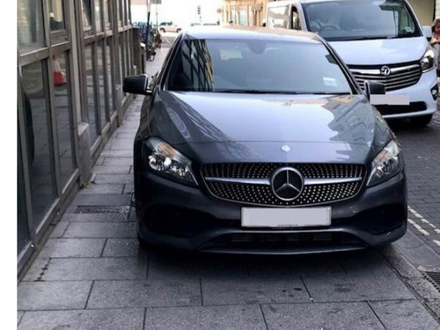 Car parked on pavement 