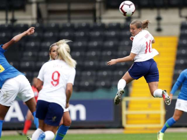England player Kirby jumps to head the ball