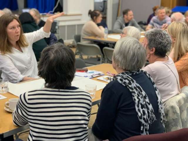Women taking about services for older people at the March event
