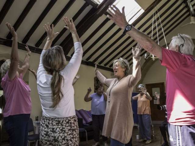 Photo of four older women doing yoga by Maria Scard