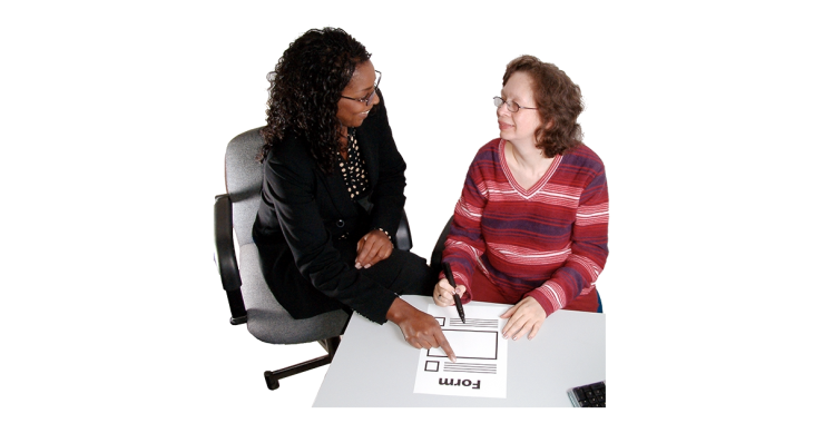 2 people filling out a form.
