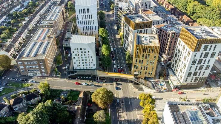 Aerial view of Lewes Road Bridge. Several tall buildings either side of a main road.