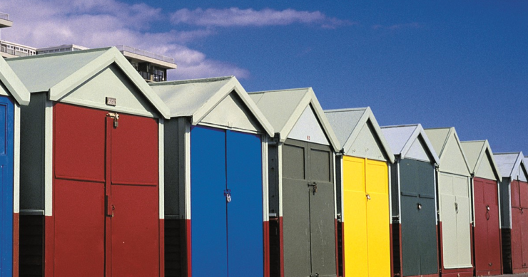 Different colour beach huts on Hove promenade.