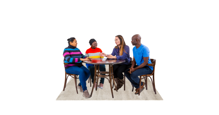Group of people sat around a table having a meeting.