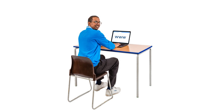 Person sitting at desk using a laptop.