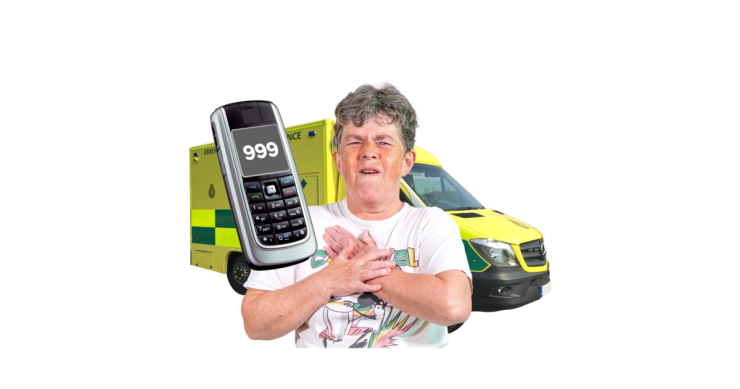 A person next to a phone which is dialled to 999 in front of an ambulance.