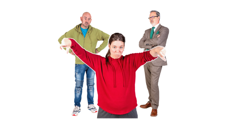 3 people standing. One person is holding their thumbs down looking sad.
