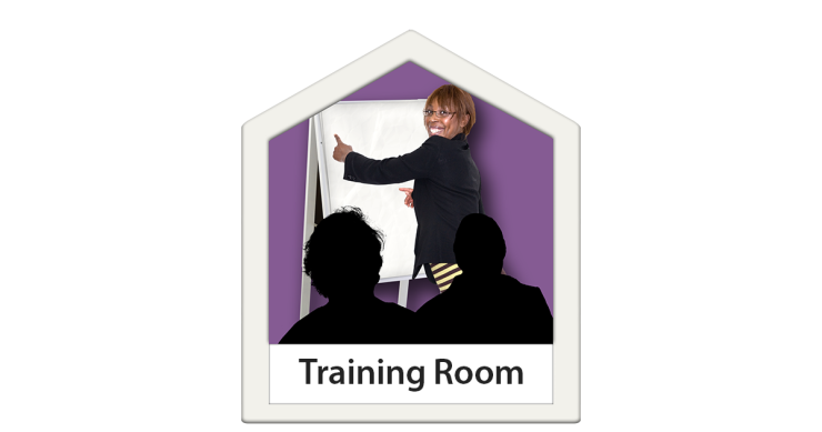 Training room with a person pointing at a flip board.