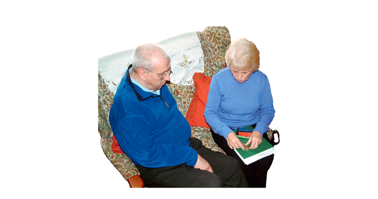 Two older people sitting at home organising their budget.