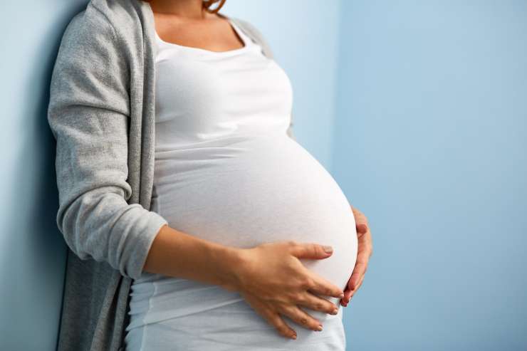 Expectant mother cradling her baby bump
