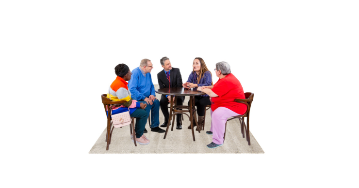 Group of people talking around a table.