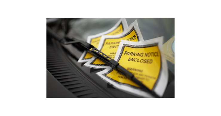 3 parking fines on the windscreen of a car.