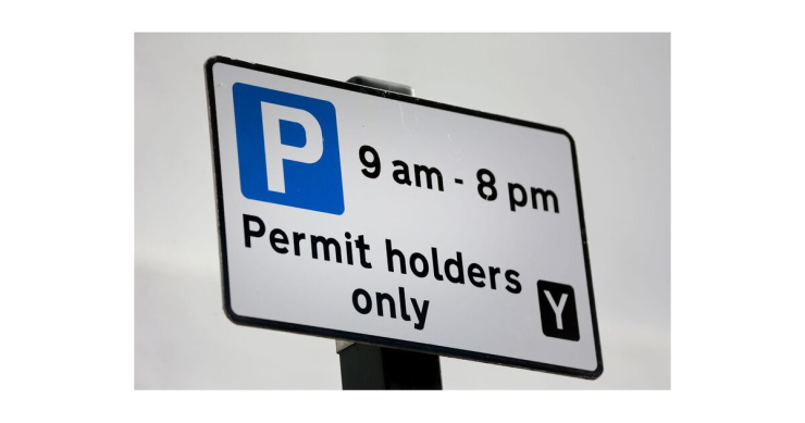 Parking permit sign telling drivers that they can only part here if they have a permit from 9am to 8pm.