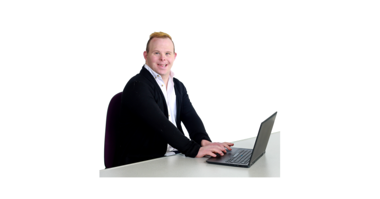 Person sitting a desk using a laptop.
