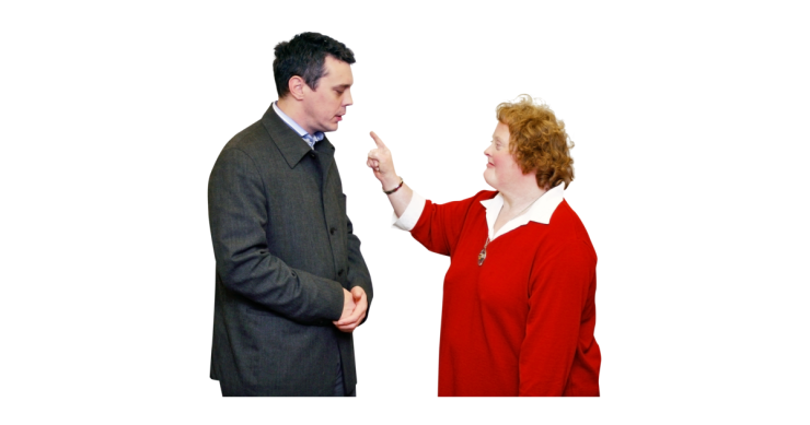 Woman complaining to a man about an issue.