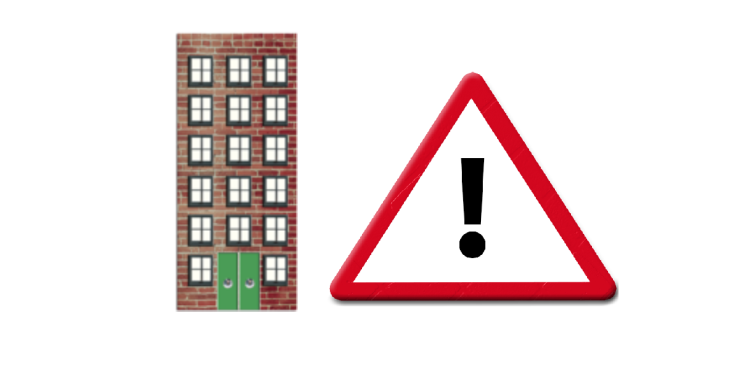 Tall building and triangle warning sign.