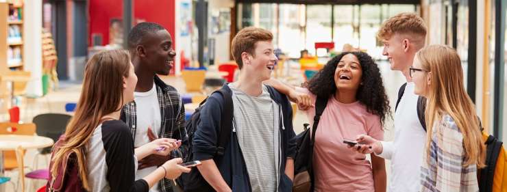 A group of teenagers talking and laughing together