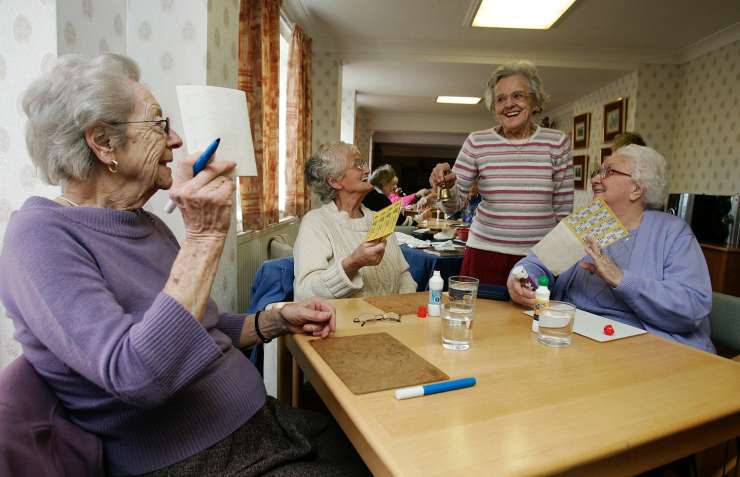 A group of people in a care home playing bingo