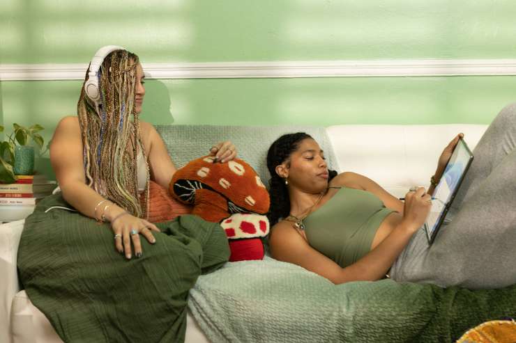 Teenagers sat on a sofa looking at an iPad