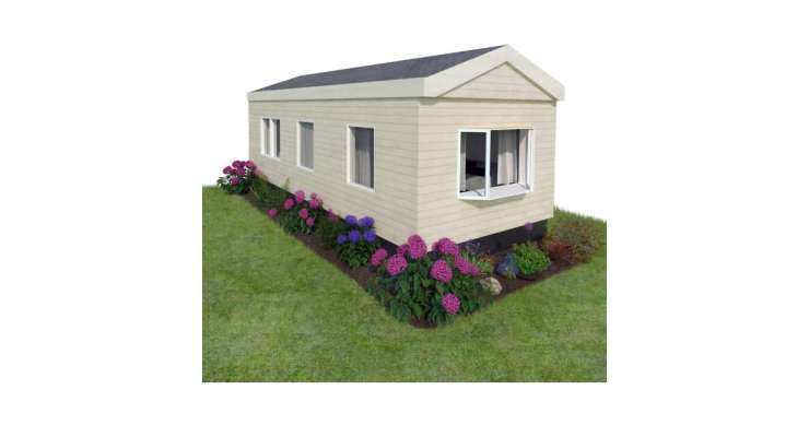 Static caravan surrounded by grass and flowers.