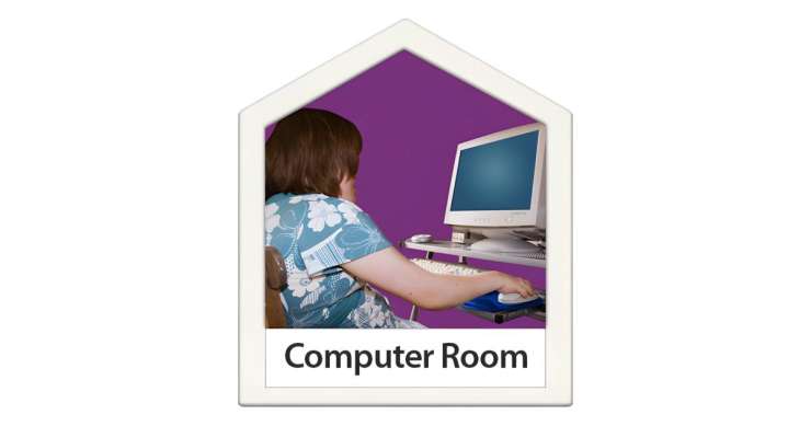 Person sitting at a computer with a monitor, keyboard and mouse. They are using the mouse.