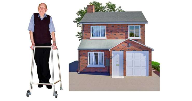 An older person with a walking frame standing next to a house.