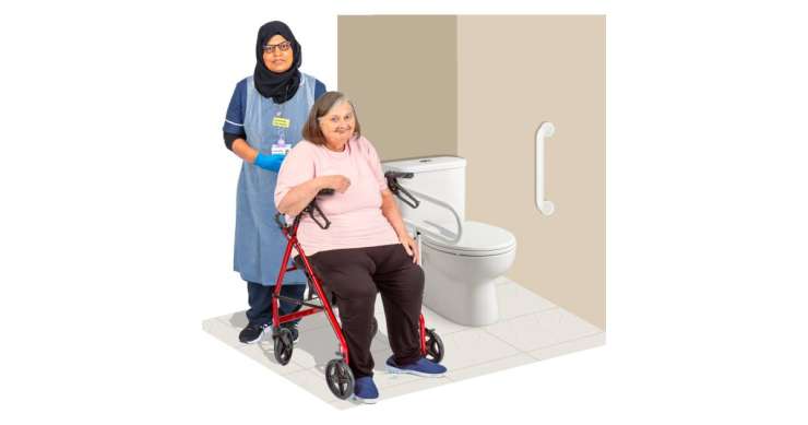 Person working in a hospital environment helping someone in a wheelchair use the toilet.