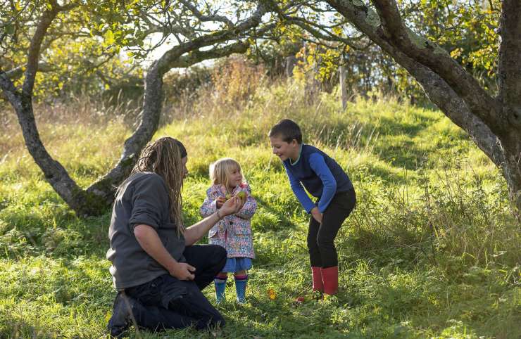 Two people and a child exploring the countryside.