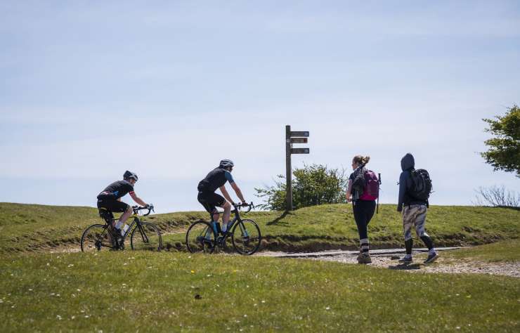 People walking a cycling in the countryside.