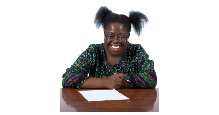 Woman writing letter on wooden table.